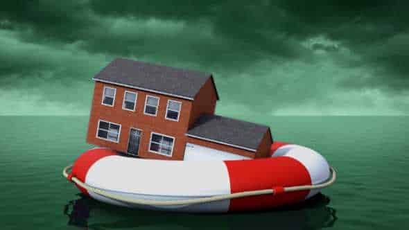 Home floating on a life raft with a storm brewing in the background. This image is to identify how home insurance might not cover your losses during a flood.